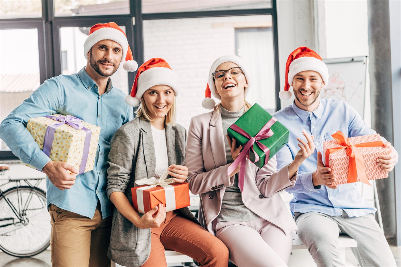 Colleagues celebrating a Christmas party with gifts