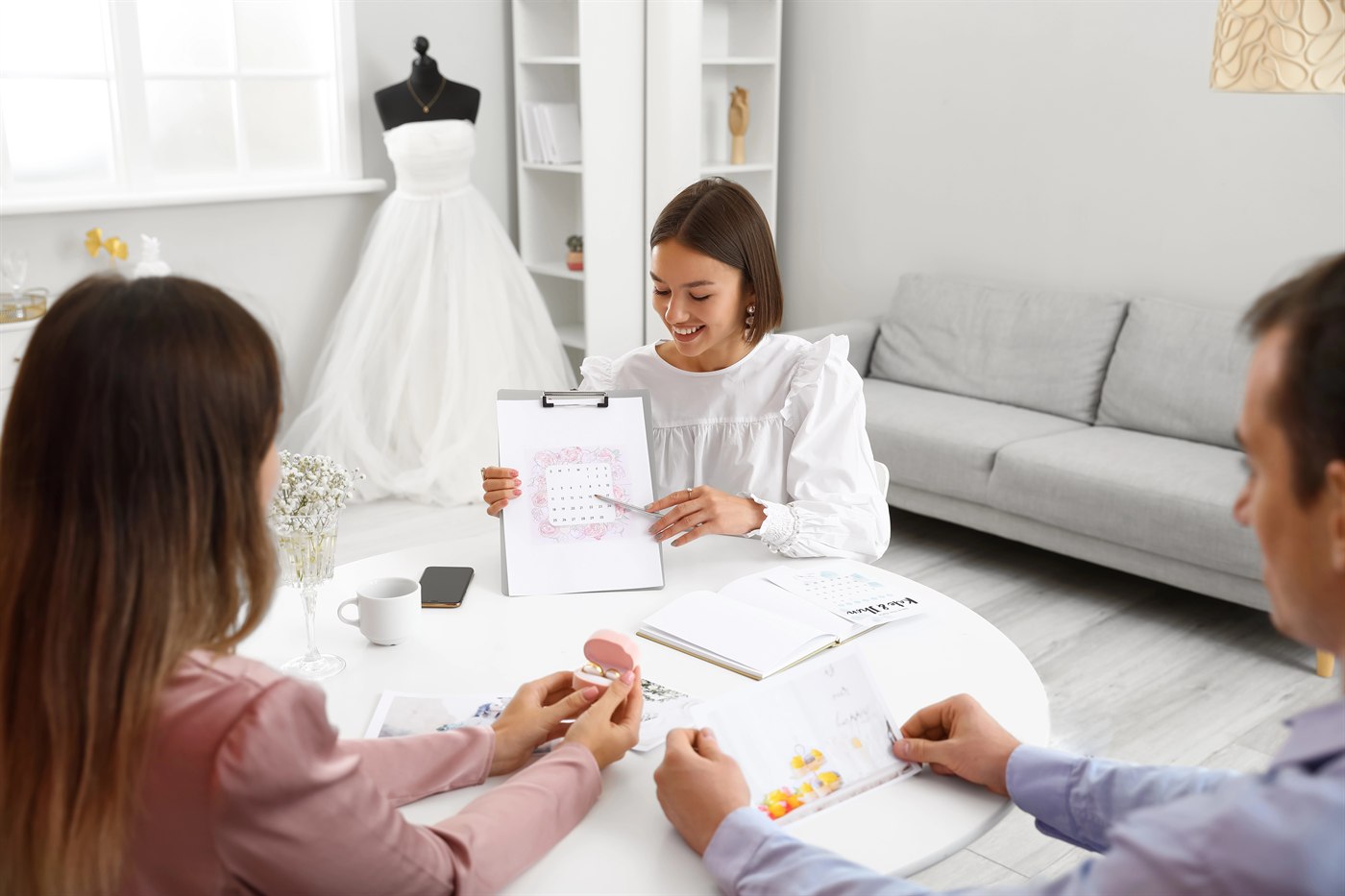 Couple meeting with a wedding planner to organise their budget